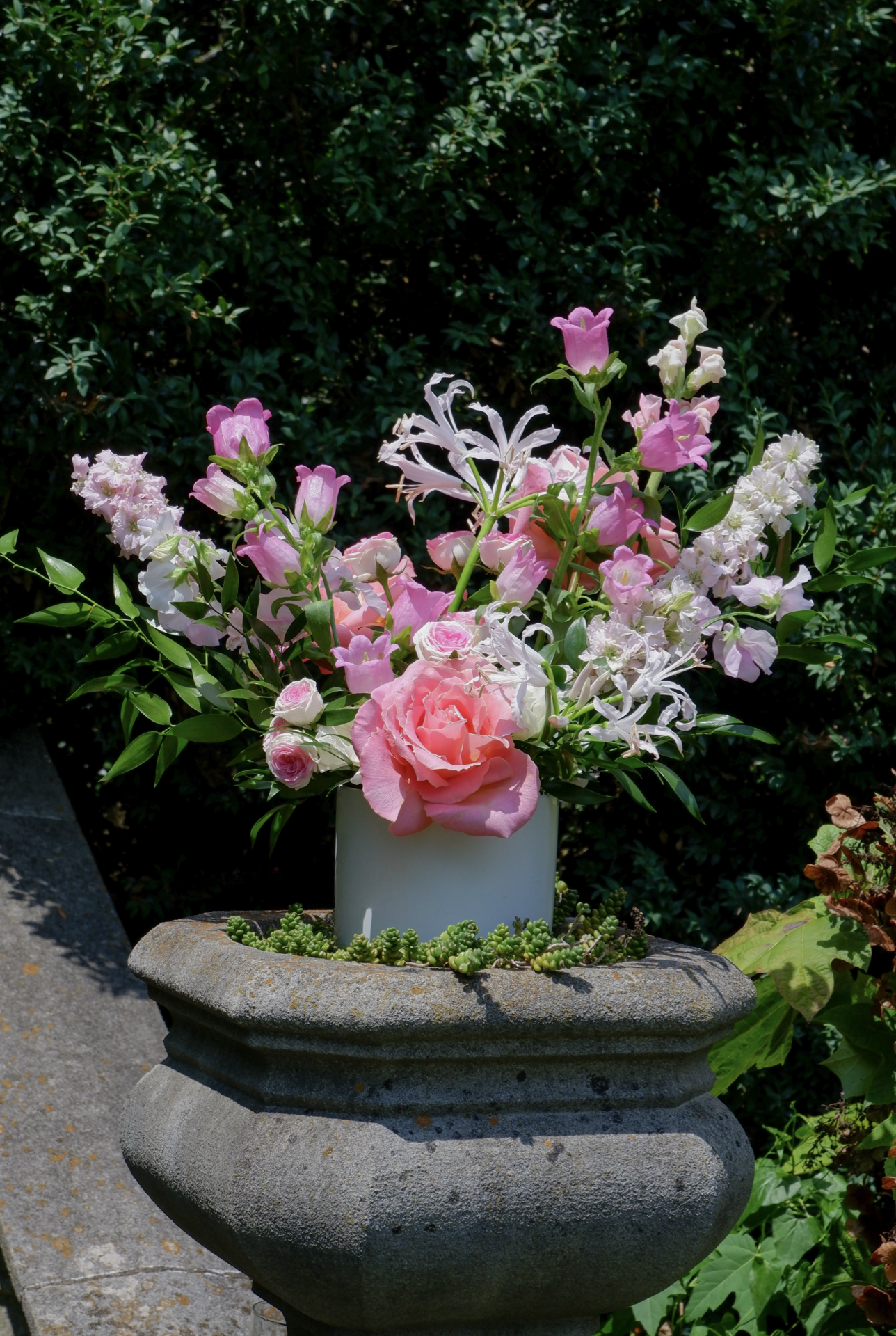 Elegant floral arrangement in a glass vase, featuring fresh seasonal blooms in vibrant colors, perfect as a versatile centerpiece or thoughtful gift. Available in multiple sizes and customizable color schemes to suit any occasion, with an option to add a personal love note